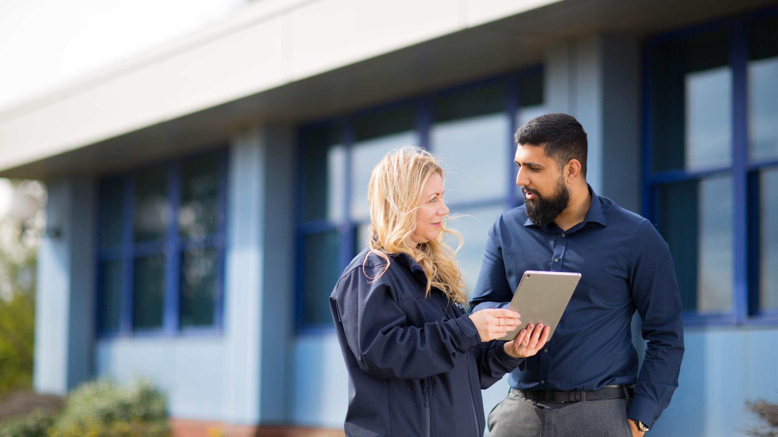 Tata steel colleague discussing item outside building